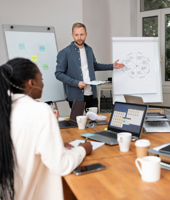 Business team conducting a presentation with charts and laptops in modern office